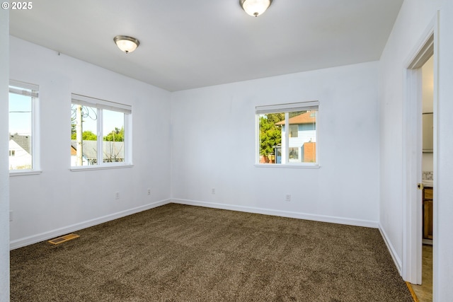 carpeted empty room with baseboards and visible vents