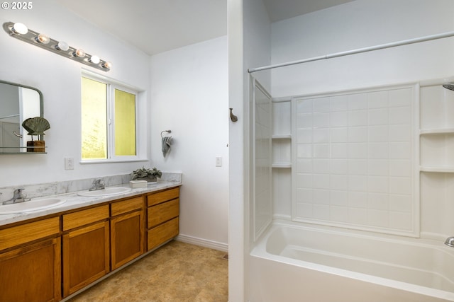 full bath featuring double vanity, a sink,  shower combination, and baseboards