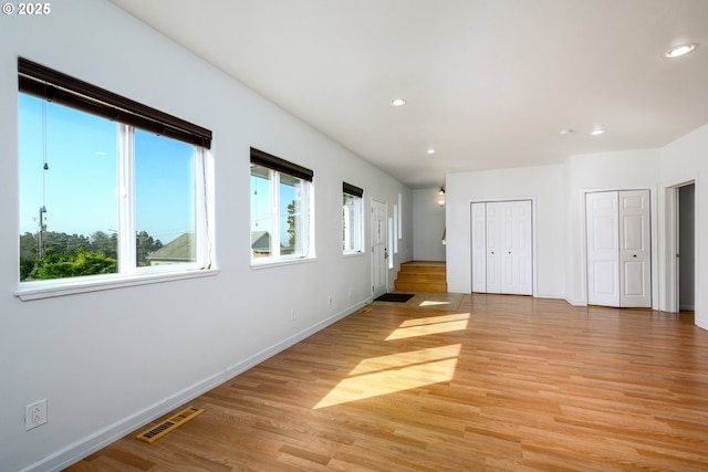 interior space featuring baseboards, light wood-style flooring, visible vents, and recessed lighting