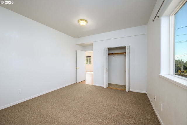 unfurnished bedroom featuring baseboards, a closet, and carpet floors