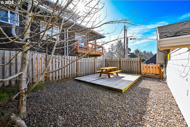 view of yard with a fenced backyard and a wooden deck