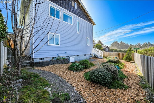 view of property exterior featuring a fenced backyard and crawl space
