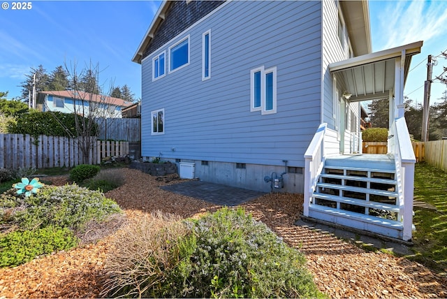 view of property exterior featuring fence and crawl space