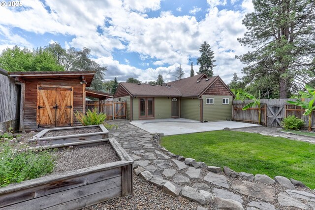 16510 SE Gordon St, Milwaukie, OR 97267 - back of house with a patio, a fenced backyard, a garden, and an outdoor structure