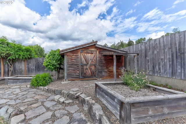 16510 SE Gordon St, Milwaukie, OR 97267 - view of shed featuring a vegetable garden and a fenced backyard
