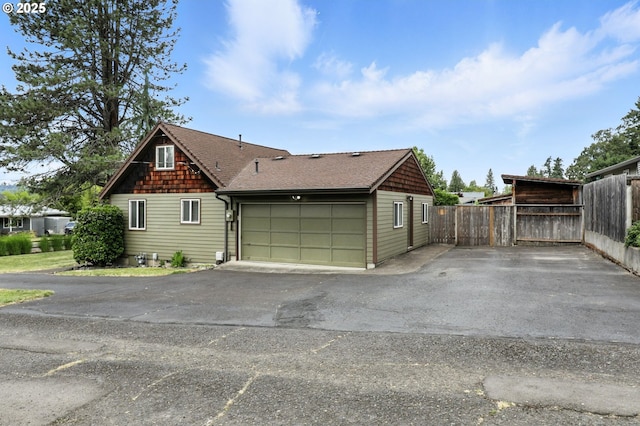 16510 SE Gordon St, Milwaukie, OR 97267 - view of side of home with asphalt driveway, a garage, and roof with shingles