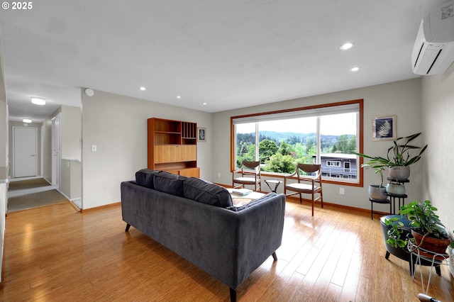 3765 Potter St, Eugene, OR 97405 - living area featuring baseboards, a wall mounted AC, light wood-type flooring, and recessed lighting