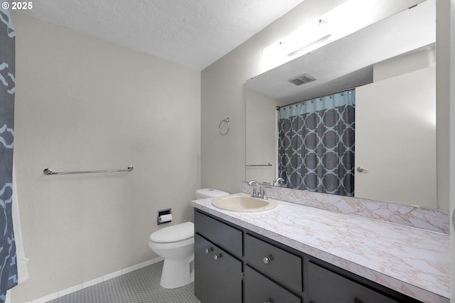 3765 Potter St, Eugene, OR 97405 - full bathroom with toilet, vanity, baseboards, a textured ceiling, and tile patterned floors