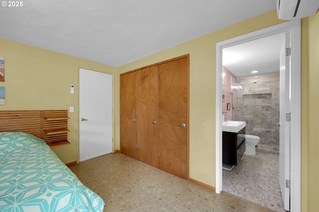 3765 Potter St, Eugene, OR 97405 - bedroom with a closet, connected bathroom, a wall mounted AC, baseboards, and a sink