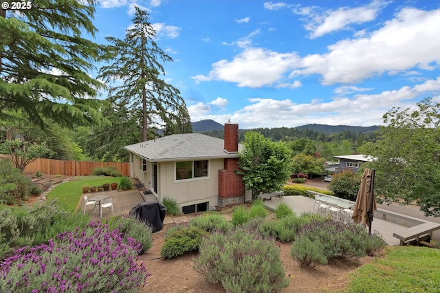 3765 Potter St, Eugene, OR 97405 - rear view of property featuring a patio, a chimney, and a mountain view