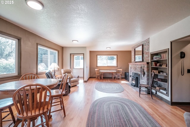 9602 Harlan Rd, Eddyville, OR 97343 - living area with a fireplace, light wood-type flooring, and a textured ceiling