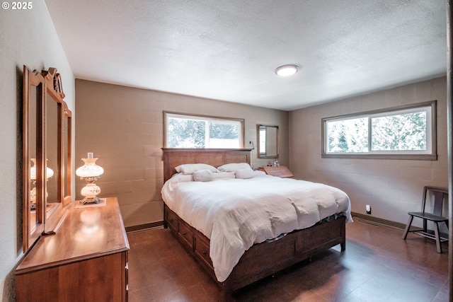 9602 Harlan Rd, Eddyville, OR 97343 - bedroom with dark floors, multiple windows, and a textured ceiling