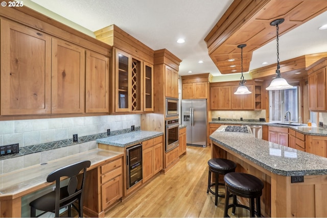 12955 SW Oxalis Ter, Portland, OR 97223 - kitchen featuring appliances with stainless steel finishes, wine cooler, open shelves, a breakfast bar area, and light wood-type flooring
