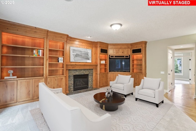 12955 SW Oxalis Ter, Portland, OR 97223 - living area featuring a fireplace, built in features, and a textured ceiling