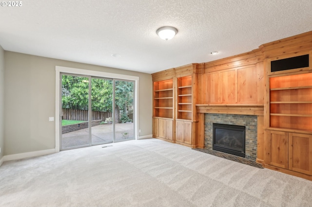 12955 SW Oxalis Ter, Portland, OR 97223 - unfurnished living room featuring a brick fireplace, carpet flooring, a textured ceiling, and built in features