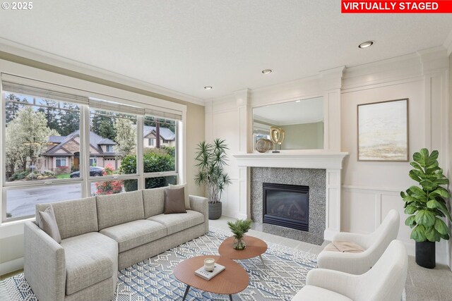 12955 SW Oxalis Ter, Portland, OR 97223 - living room featuring crown molding, a decorative wall, and a premium fireplace