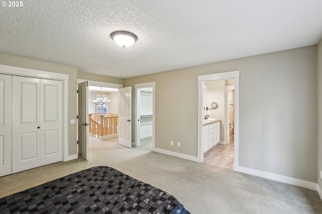 12955 SW Oxalis Ter, Portland, OR 97223 - unfurnished bedroom with a chandelier, light carpet, ensuite bathroom, a closet, and a textured ceiling