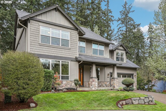 12955 SW Oxalis Ter, Portland, OR 97223 - craftsman-style home featuring a front lawn, a garage, asphalt driveway, stone siding, and a shingled roof