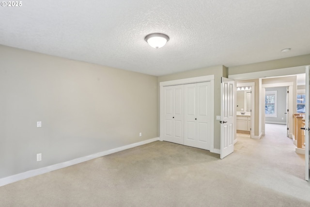 12955 SW Oxalis Ter, Portland, OR 97223 - unfurnished bedroom with a closet, light carpet, and a textured ceiling