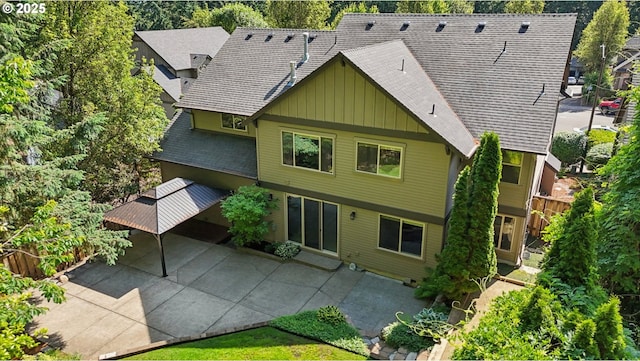 12955 SW Oxalis Ter, Portland, OR 97223 - back of house featuring board and batten siding, a shingled roof, and a patio
