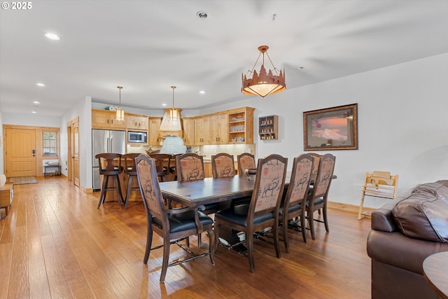 dining area featuring baseboards, recessed lighting, and light wood-style flooring