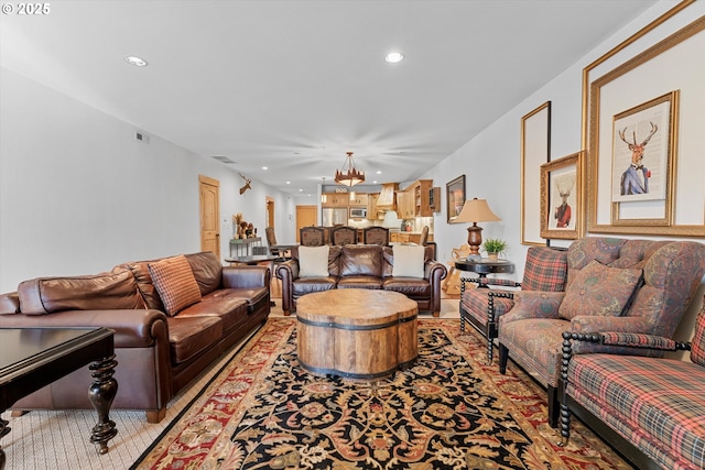 living room featuring recessed lighting, a chandelier, and visible vents