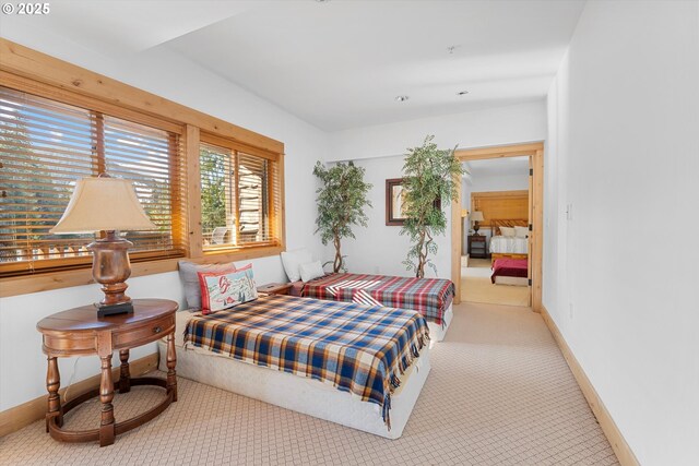 carpeted bedroom featuring baseboards