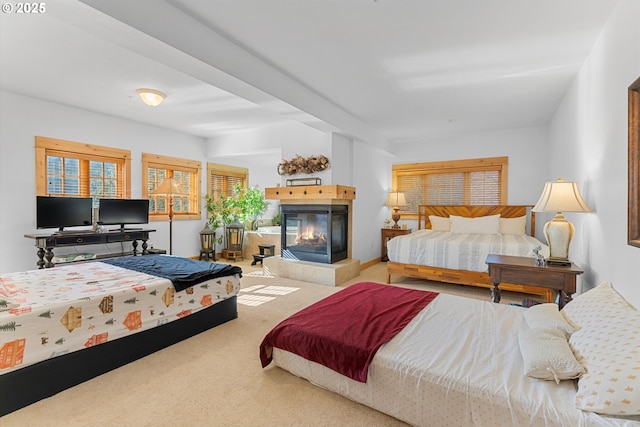 carpeted bedroom featuring a tile fireplace