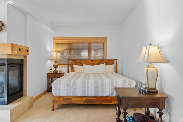 carpeted bedroom with a tiled fireplace
