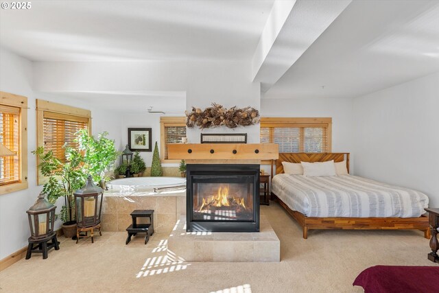 carpeted bedroom with baseboards and a fireplace