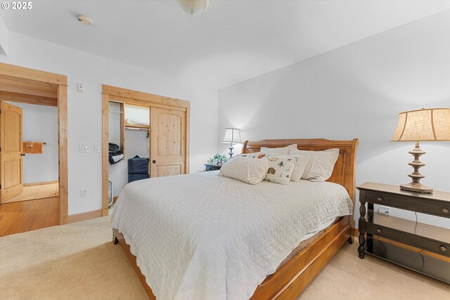 carpeted bedroom featuring a closet and baseboards