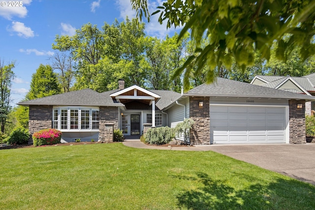 view of front of house with stone siding, an attached garage, a front lawn, and concrete driveway