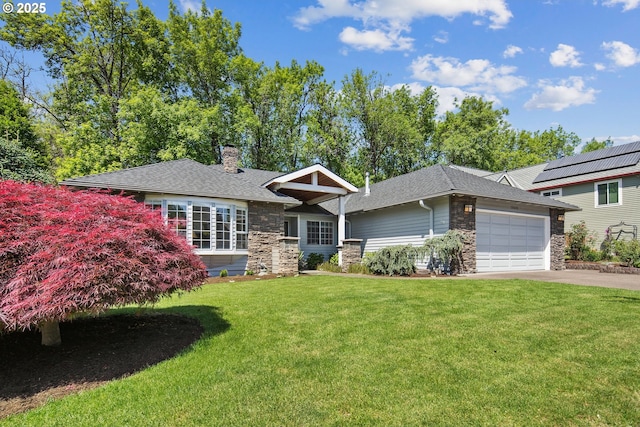 view of front of home featuring stone siding, a front lawn, driveway, and a garage