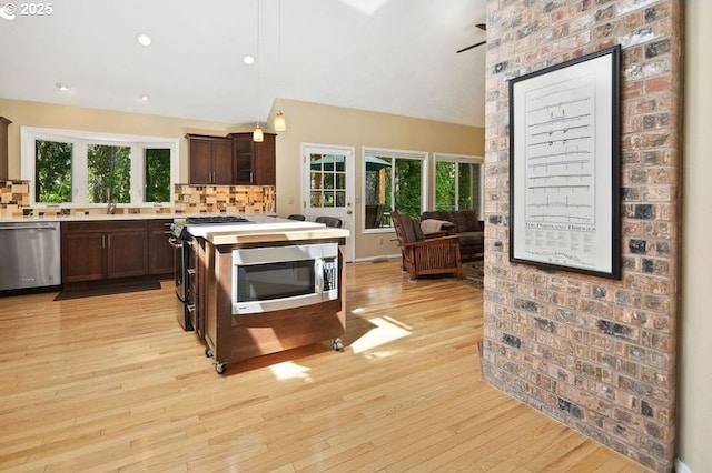 kitchen with stainless steel appliances, light countertops, tasteful backsplash, dark brown cabinets, and recessed lighting