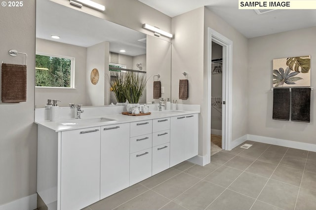 bathroom with tile patterned floors and vanity