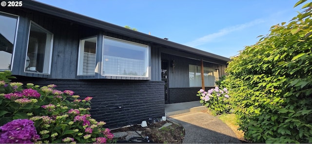 14128 NE Rose Pkwy, Portland, OR 97230 - view of side of property with brick siding and board and batten siding