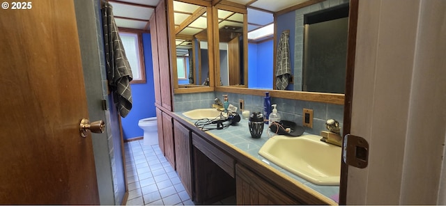 14128 NE Rose Pkwy, Portland, OR 97230 - bathroom with double vanity, tile patterned flooring, and backsplash