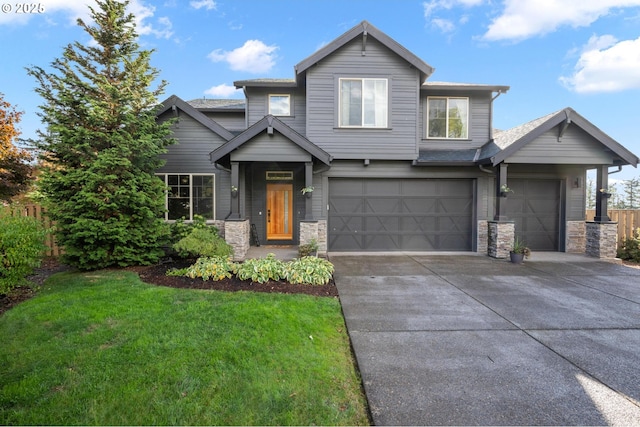 view of front of home featuring a garage, stone siding, a front yard, and driveway