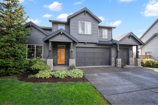 view of front of home with an attached garage, stone siding, a front lawn, and concrete driveway