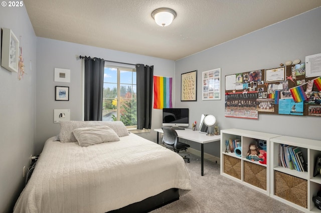 bedroom featuring carpet floors and a textured ceiling