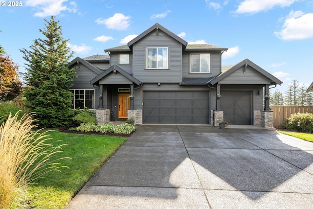 craftsman-style house featuring a garage, stone siding, fence, and concrete driveway