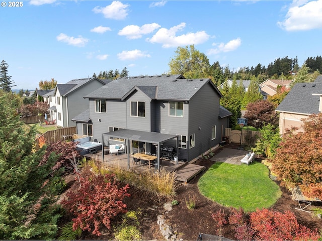 back of house with a lawn, a patio area, a residential view, a fenced backyard, and a jacuzzi