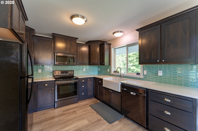 510 SE 130th Dr, Newport, OR 97366 - kitchen featuring stainless steel appliances, light countertops, dark brown cabinetry, and tasteful backsplash