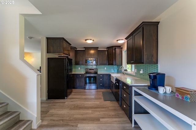 510 SE 130th Dr, Newport, OR 97366 - kitchen featuring black appliances, dark brown cabinetry, light countertops, and backsplash