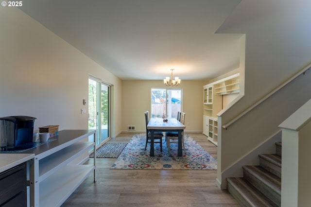 510 SE 130th Dr, Newport, OR 97366 - dining space featuring a chandelier, light wood-style flooring, and stairs