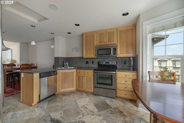168 N Pacific St, Rockaway Beach, OR 97136 - kitchen featuring appliances with stainless steel finishes, a sink, dark countertops, tasteful backsplash, and recessed lighting