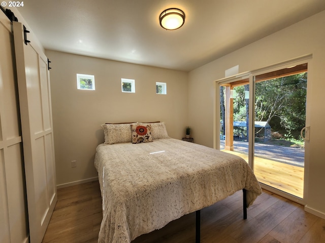 bedroom featuring dark wood-type flooring, access to outside, and baseboards