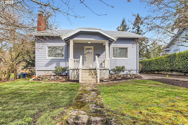 bungalow with a front yard and a chimney