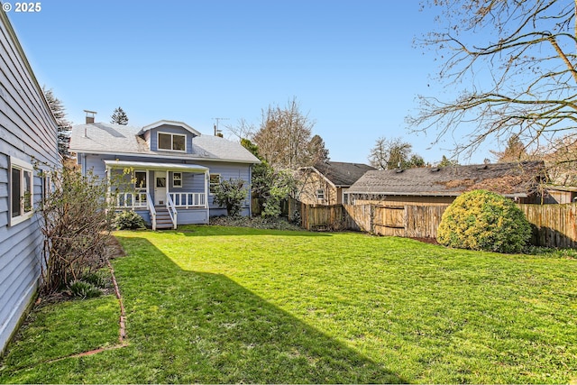 view of yard featuring a porch and fence