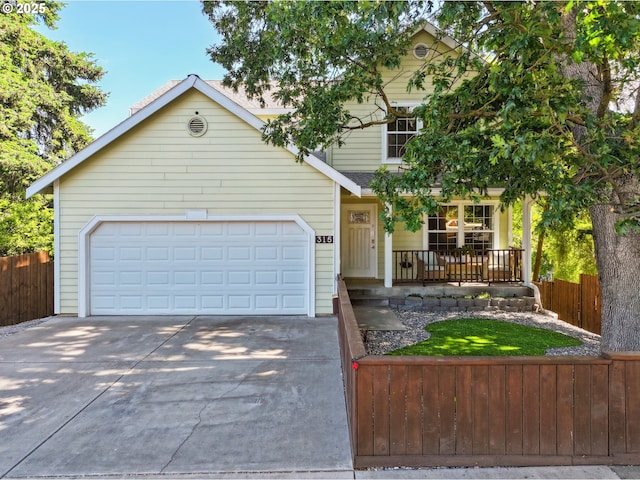 315 W 13th St, The Dalles, OR 97058 - view of front of house with covered porch, concrete driveway, and a garage